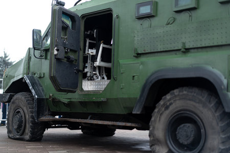 At a public demonstration, a military vehicle sits prominently, showcasing its open door and the specialized equipment inside. The sturdy design highlights its functionality and purpose.の写真素材