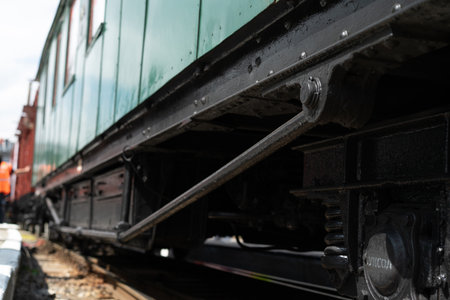 Close-up view of a rail car's mechanical components captured at a vintage train exhibition,...