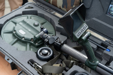 A specialized bomb disposal kit is opened to reveal various tools, including detectors and controls, used for safe explosive handling and disarmament during training or demonstrations.の写真素材