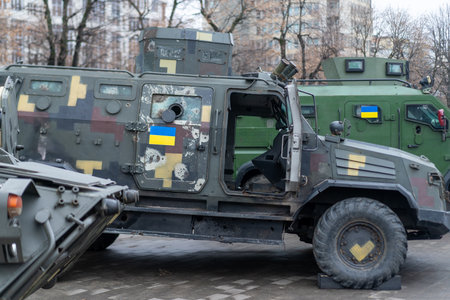 Various military vehicles are positioned in an urban setting, featuring camouflage patterns and...