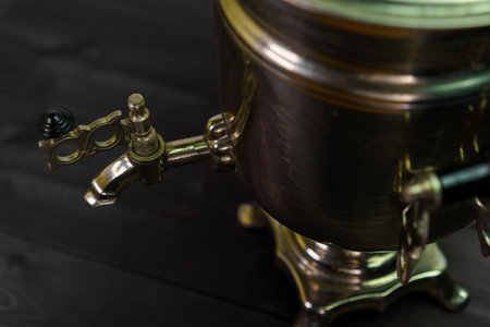 A beautifully crafted brass beverage dispenser features intricate designs and a shiny finish. It is...
