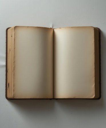 A beautiful vintage open book featuring blank pages, perfect for writing, drawing, or capturing thoughts. Ideal for creative projects or as a background.の素材