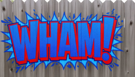 A vibrant comic-style "WHAM!" text burst on a wooden fence. Ideal for conveying excitement, action, or surprise in creative projects and designs.の素材
