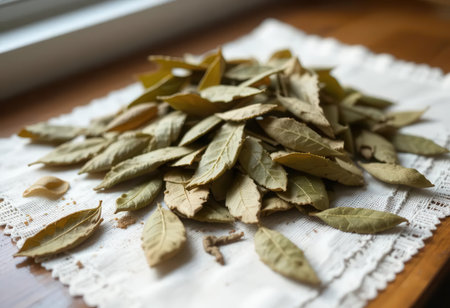A beautiful arrangement of dried bay leaves on a rustic linen cloth, showcasing their earthy texture and vibrant hues, ideal for culinary use or decoration.の素材