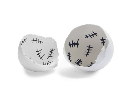 Close-up shot of a empty eggshell with five count strokes inside it. 