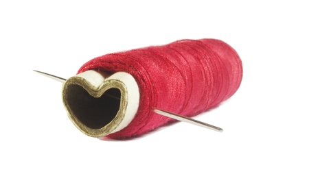 Image of needle through heart shape spoolの写真素材