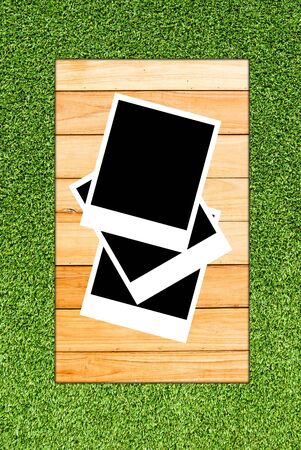 photoframe on wood and grass backgroundの写真素材