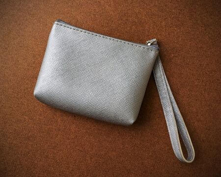 silver leather coin bag on wood background.の写真素材
