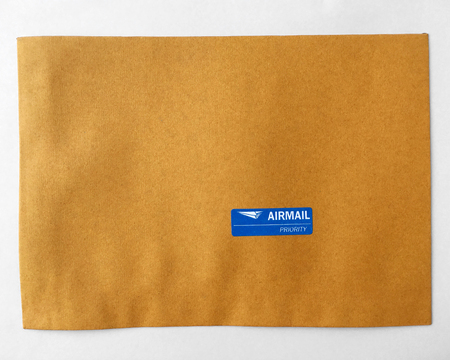 airmail priority sticker on brown paper.の写真素材