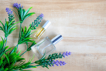 Perfume bottle and purple flower On a wooden backgroundの写真素材