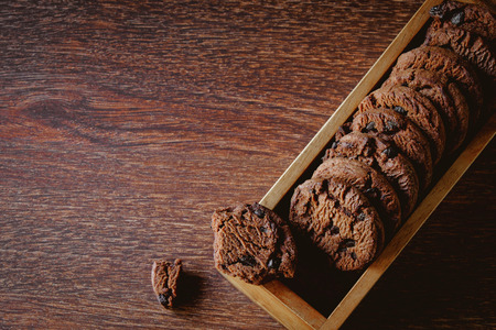 Chocolate cookies in a cup on a wooden table