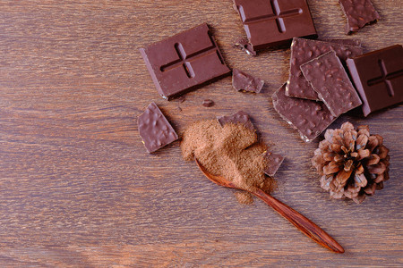 Chocolate bars and powdered chocolate On a wooden backgroundの写真素材