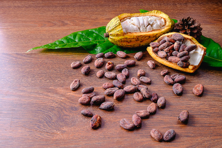 Cocoa fruit background with cocoa pods and cocoa beans on wood table