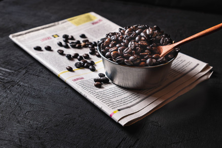 Raw coffee beans in a cupの写真素材