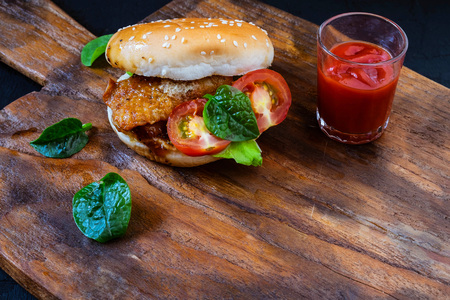 hamburger with fresh vegetables on wood