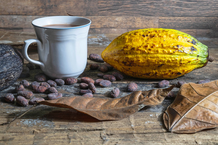 Cocoa cup and cocoa fruit on wooden tableの写真素材
