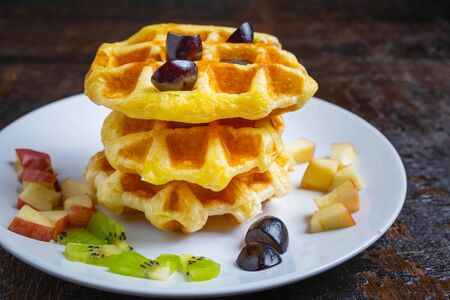 Delicious waffles in a plate on the table
