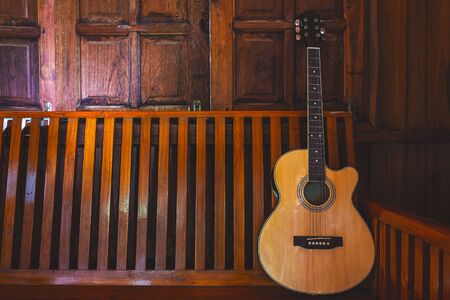 Acoustic guitar placed on wooden floorsの写真素材