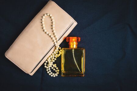 Perfume bottles and women handbags with beautiful jewelryの写真素材