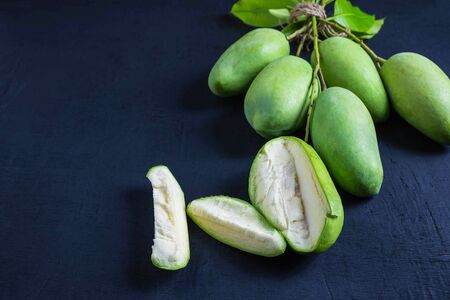 Fresh green mango fruit on a wooden tableの写真素材