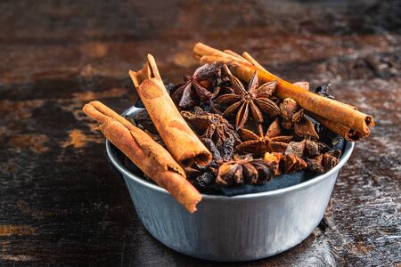 Cinnamon spices and anise stars in a bowl on the tableの写真素材