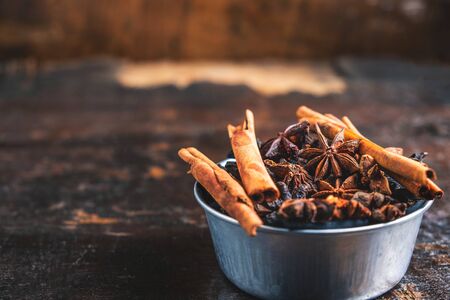 Cinnamon spices and anise stars in a bowl on the tableの写真素材
