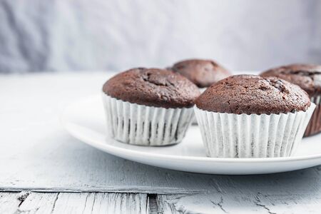 bakery chocolate cupcakes in a dish on a white backgroundの写真素材