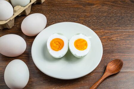 White duck eggs and salted egg food on a wooden tableの写真素材