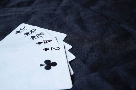 Gambling cards on a black cloth backgroundの写真素材