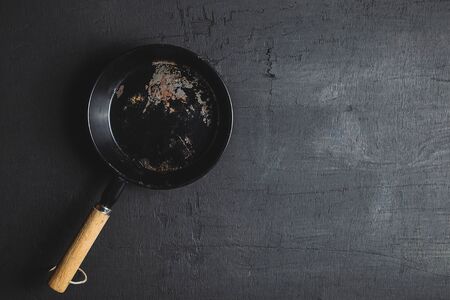 A pan for cooking on a black backgroundの写真素材
