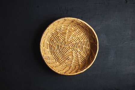 A wooden basket on a black backgroundの写真素材
