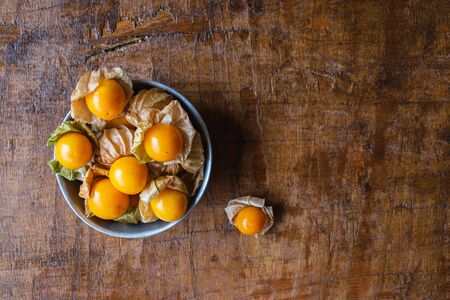 Cape Gooseberry fruit In a bowl on a wooden backgroundの写真素材