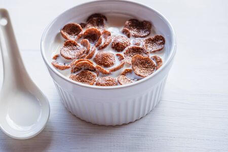 Breakfast cereal with fresh milk on the white table