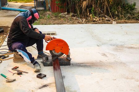 The iron cutter is cutting steel.