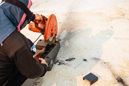 The iron cutter is cutting steel.