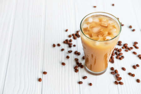 Iced coffee in a glass On a white wooden backgroundの写真素材