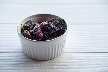 Fresh mulberry in a bowl on the tableの写真素材