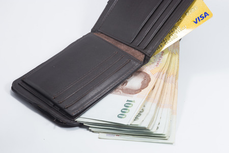 Brown wallet with Thai banknote on white background