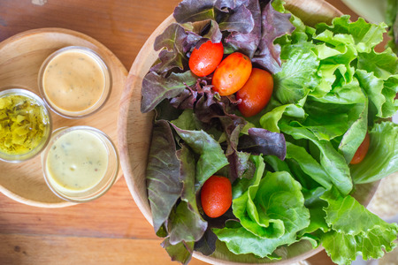 Fresh healthy salad on wooden table. Top viewの写真素材