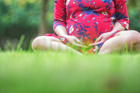 pregnant woman relaxing and happy in the parkの写真素材