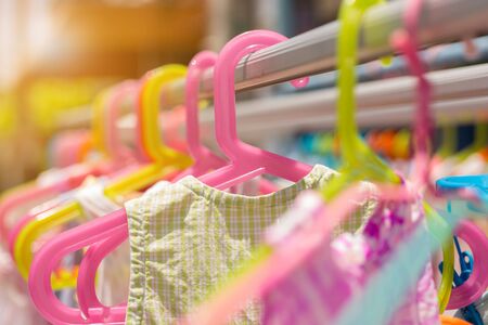 Hang dry baby clothes colorful hanger in outdoorの写真素材