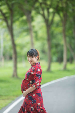 pregnant woman relaxing and happy in the parkの写真素材