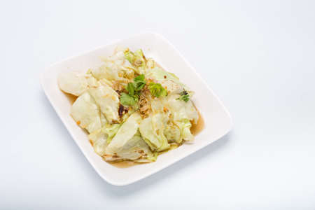 Stir Fried Cabbage with Fish Sauce, White Square Plate on white backgroundの写真素材