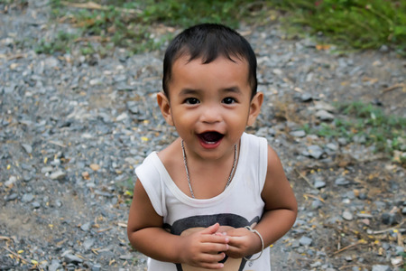 Asian little boy sits on a in a park,Asian little boyの写真素材
