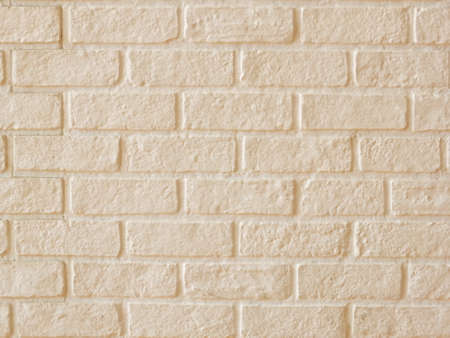 Masonry pattern, rough surface, painted light yellowの写真素材