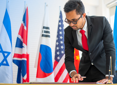 The business man or politician with eye glasses is working in office during international conferenceの写真素材