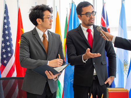 The journalist interviews business man or politician in the international conference and one of them act as secretaryの写真素材