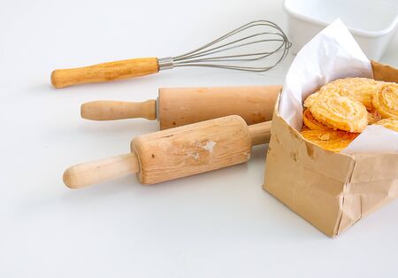 Several equipment or tools for bakery cooking including rolling pin, whisk and bowl or cup, all are...