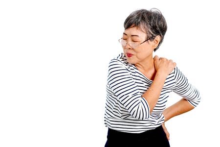 One Asian elderly woman express action of shoulder pain and isolate on white background with copy space.の写真素材