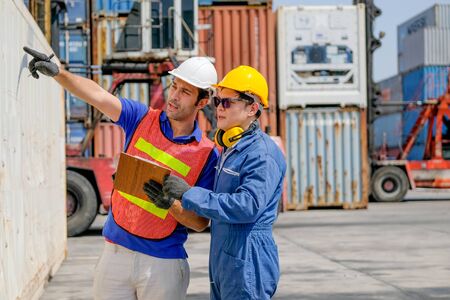 Technician and engineer work together for checking quality and product in cargo container shipping...